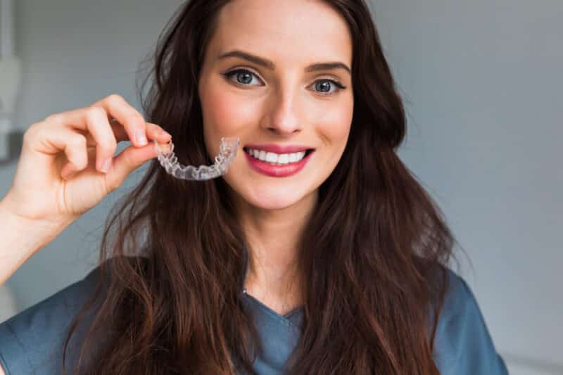 woman holding Invisalign