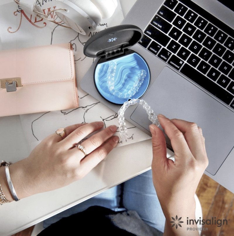 patient holding invisalign at desk