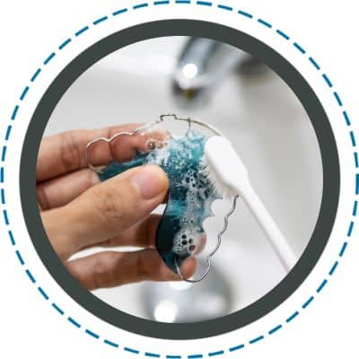 cleaning retainer with a toothbrush
