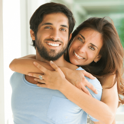 Man and woman couple smiling after adult orthodontic treatment