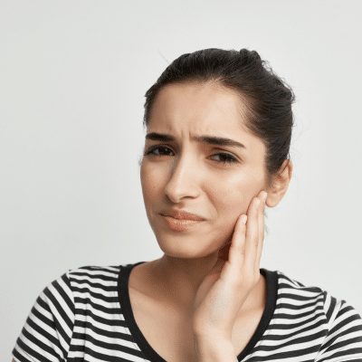 Woman holding jowl because of dental problems
