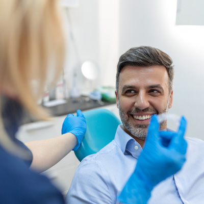 dentist showing invisalign to patient