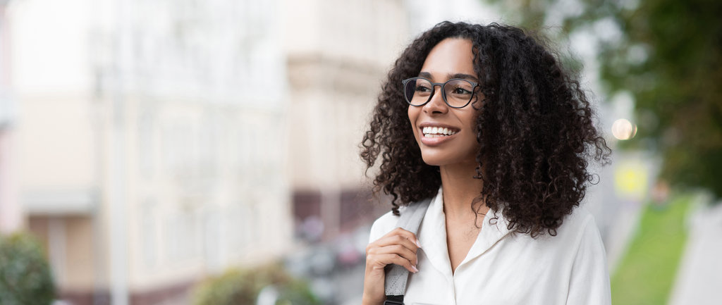 Young beautiful woman smiling in a city panoramic banner, pretty student girl portrait, young businesswoman standing outdoor, copy space