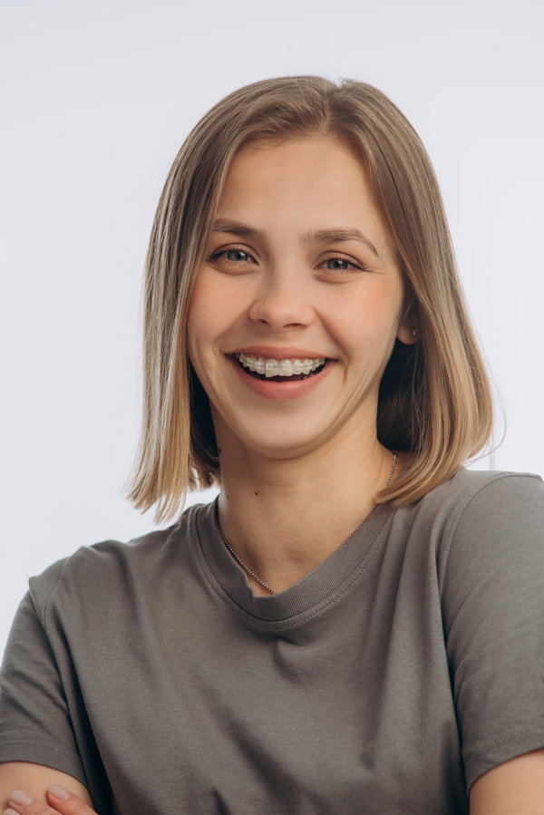portrait of a young beautiful girl with braces, on a white background Airways and Orthodontics