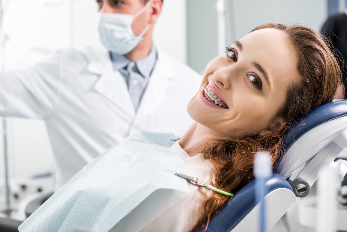 selective focus of beautiful woman in braces during examination Airways and Orthodontics