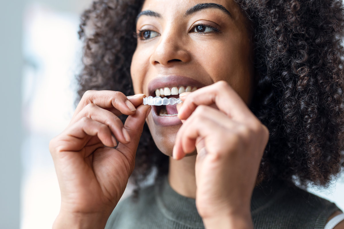 Woman wearing orthodontic silicone trainer. Invisible braces aligner. Airways and Orthodontics